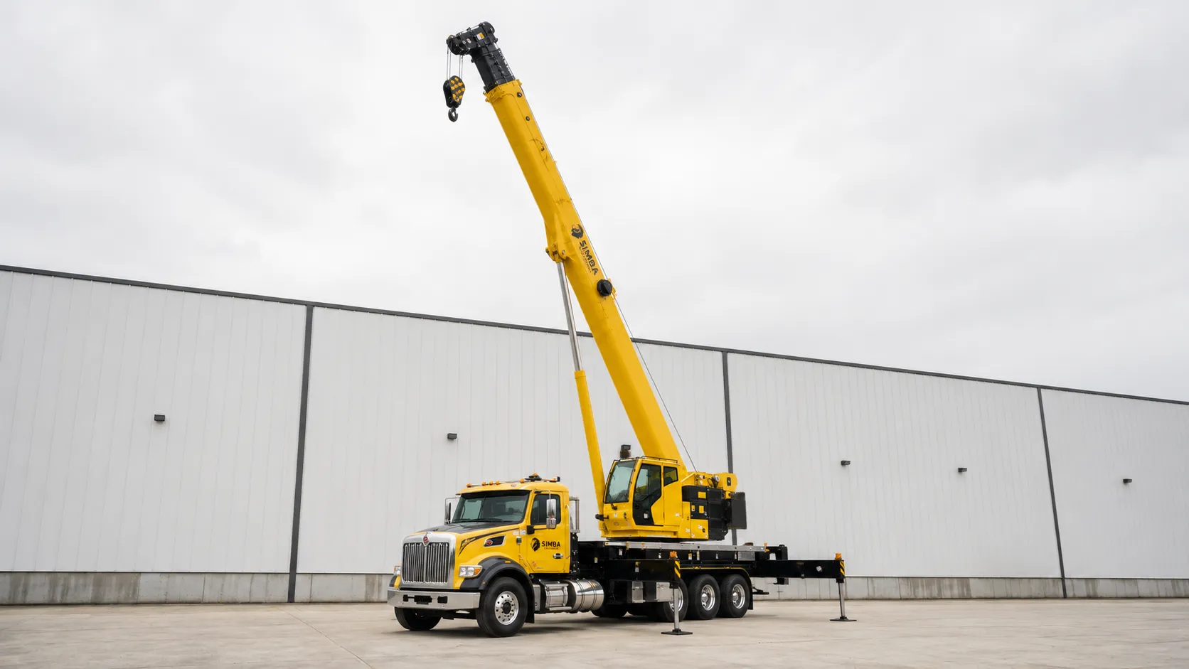 Truck mounted crane with boom extended on a job site